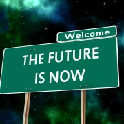 Schild vor Nachthimmel: "THE FUTURE IS NOW"